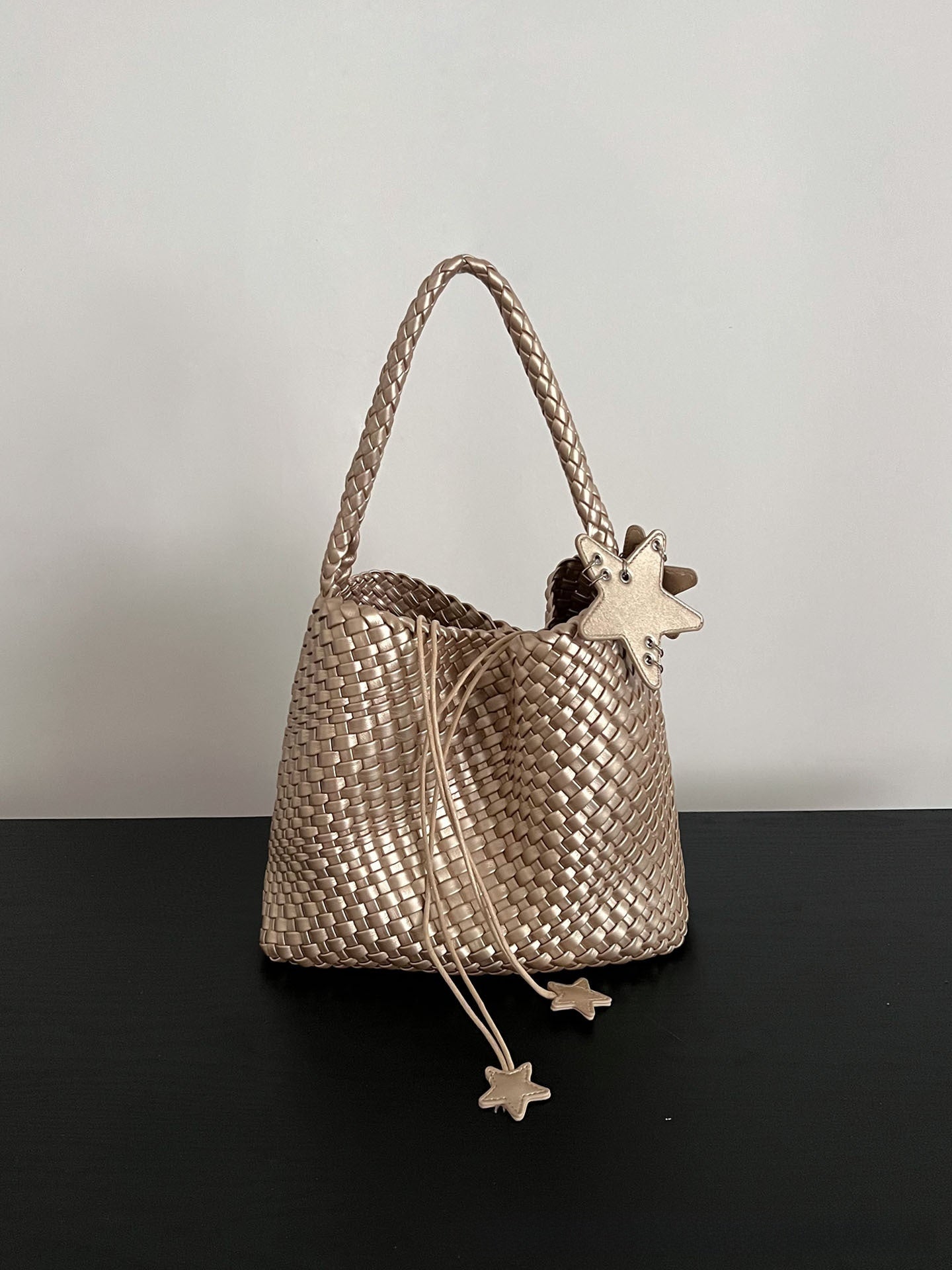 Champagne-colored woven tote bag
